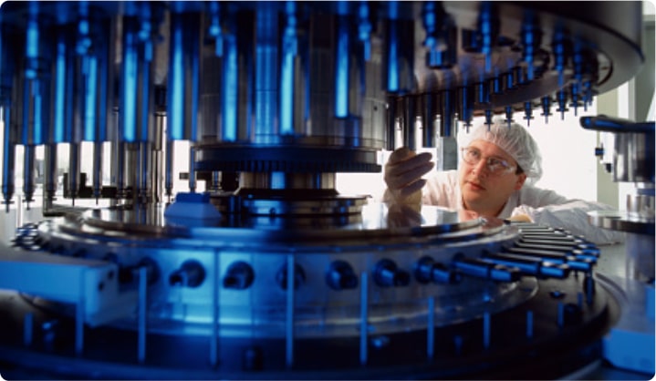Plant supervisor in front of manufacturing machine